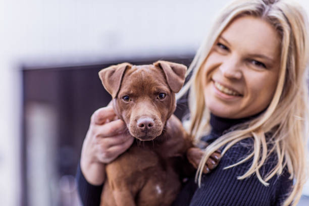 istock Blonde woman with a puppy 1219983826