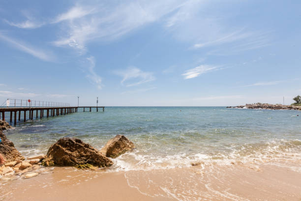 istock Beach with rocks and blue sky. Summer vacation background 1219983951
