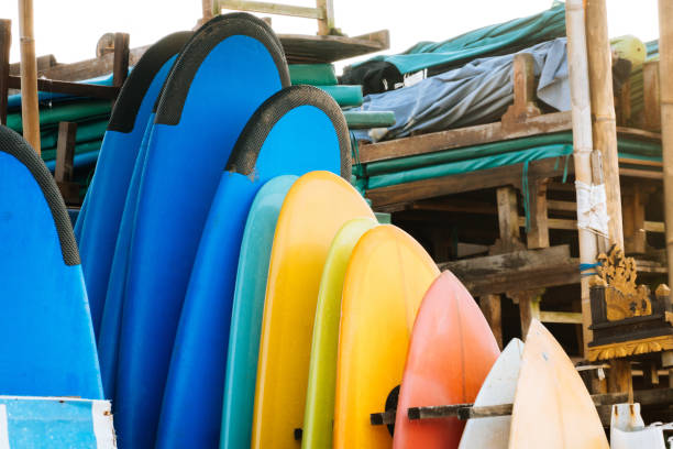 istock Set of different color surf boards in a stack by ocean.Bali.Indonesia. Surf boards on sandy beach for rent. Surf lessons on Weligama beach, Sri Lanka. 1219984164