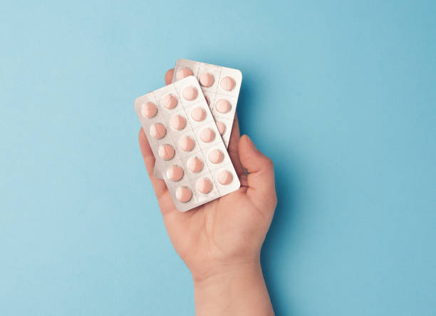 istock hand hold a package of round tablets in blister packs 1219985440