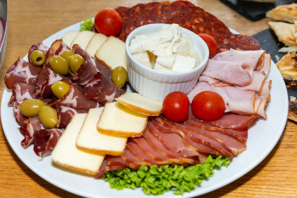 istock Slices of different sausage, ham and salami 1219985555