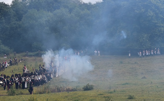Waterloo / Belgium - June 24 2018 : Soldiers are firing their rifles with blank shots in the reenactment of Waterloo Battle