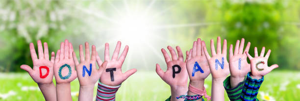 istock Kids Hands Holding Word Do Not Panic, Grass Meadow 1219990602