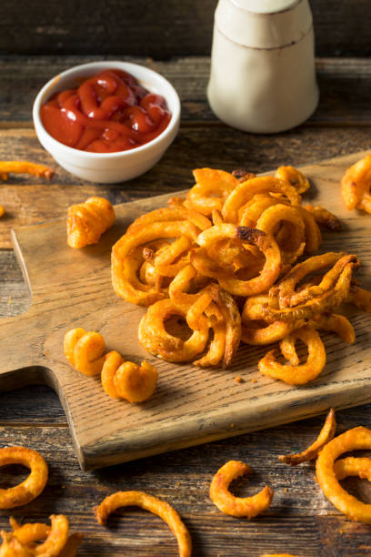 Homemade Seasoned Curly French Fries Homemade Seasoned Curly French Fries with Ketchup curly fries stock pictures, royalty-free photos & images