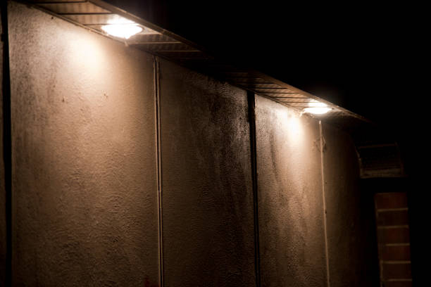 istock Two large pot lights illuminating a concrete wall in the dark 1219991763