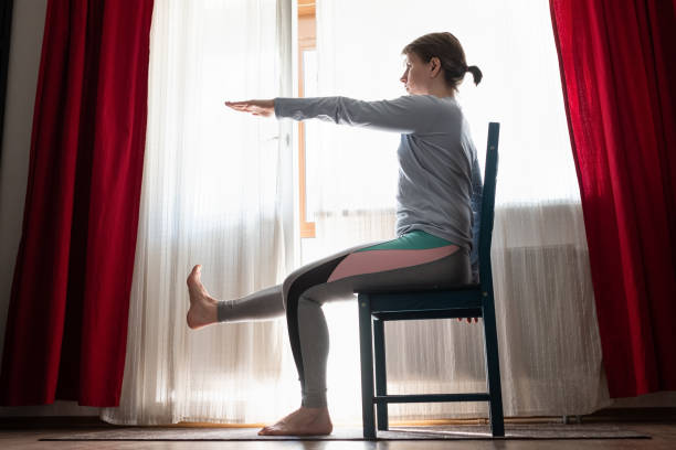 istock Beautiful young girl doing exercises at home 1219991816