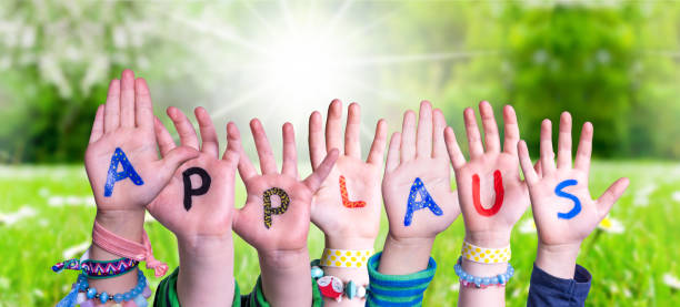 Children Hands Building Word Applause Means Applause, Grass Meadow Children Hands Building Colorful German Word Applaus Means Applause. Sunny Green Grass Meadow As Background applaus stock pictures, royalty-free photos & images