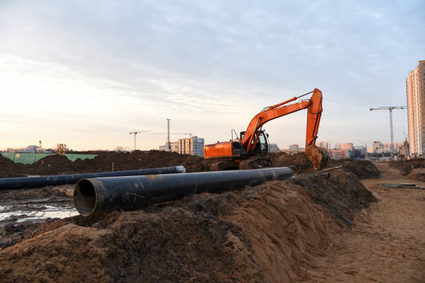 istock Red excavator at building under construction against the background  sunset 1219993339
