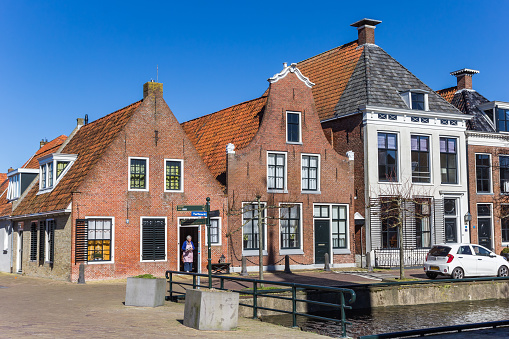 A long row of traditional apartment buildings, set alongside one of the historic canals in Amsterdam's city centre.