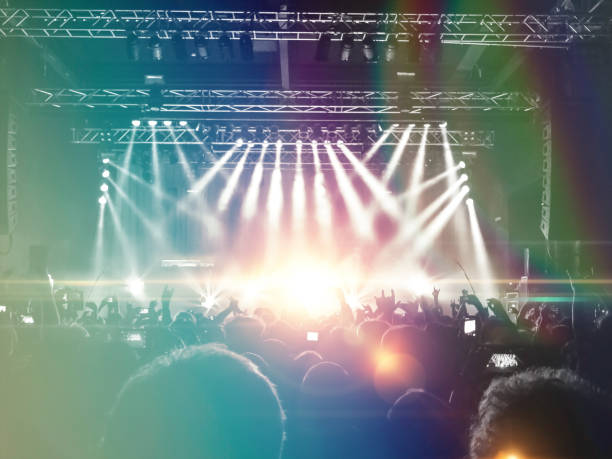 concert stage, people are visible waving and clapping, silhouettes are visible - concert hall crowd dancing nightclub imagens e fotografias de stock