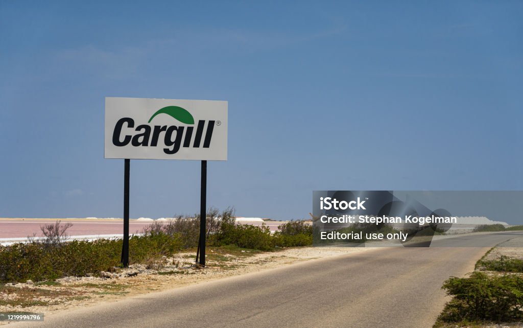 Sea Salt is harvest from the Saltpans on Bonaire by Cargill Kralendijk, Bonaire - April 19 2020: The Cargill company holds on Bonaire a Sea Salt plant, which is done by evaporation of sea water in the open air. Which gives Salt crystals. Agricultural Activity Stock Photo