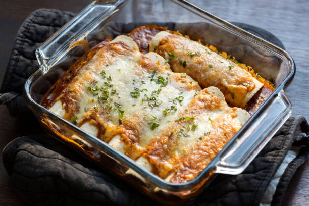 Vegetarian Enchiladas Vegetarian Enchiladas in a red sauce filled with beans and vegetables and smothered with cheese. enchilada stock pictures, royalty-free photos & images