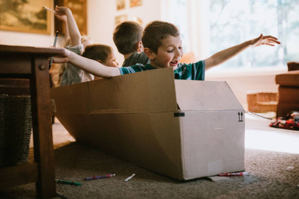 istock Children Play And Imagine In Cardboard Box At Home 1219995541