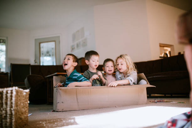 istock Children Play And Imagine In Cardboard Box At Home 1219995552