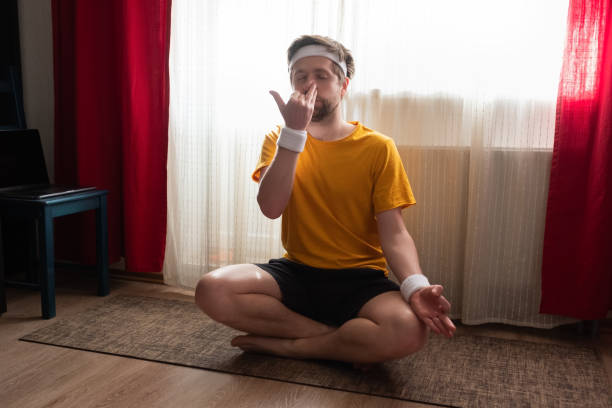 uomo che fa esercizio di respirazione narice alternativa, nadi shodhana pranayama - pranayama foto e immagini stock