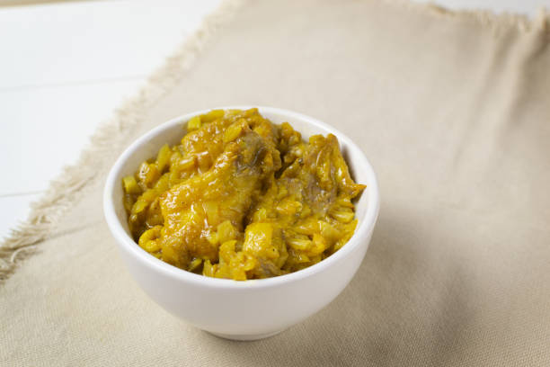 istock Appetizing Chicken with curry in a cream bowl on a white background. A traditional dish of Indian cuisine. 1219999813