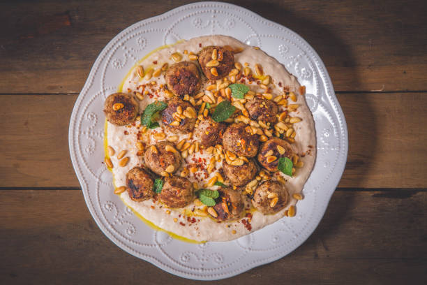 Meat balls served on humus suace.