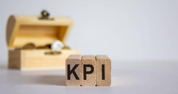 istock Concept word KPI on cubes on a beautiful white background, small chest with coins. 1220000319