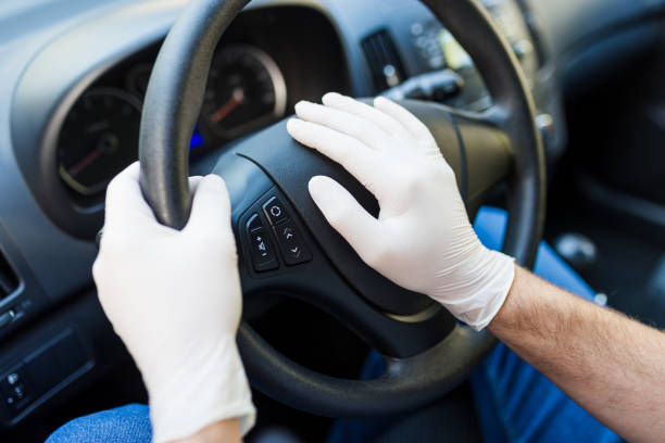 istock Driver hands wearing surgical rubber gloves on steering wheel, antibacterial protection covid-19 concept. 1220002249