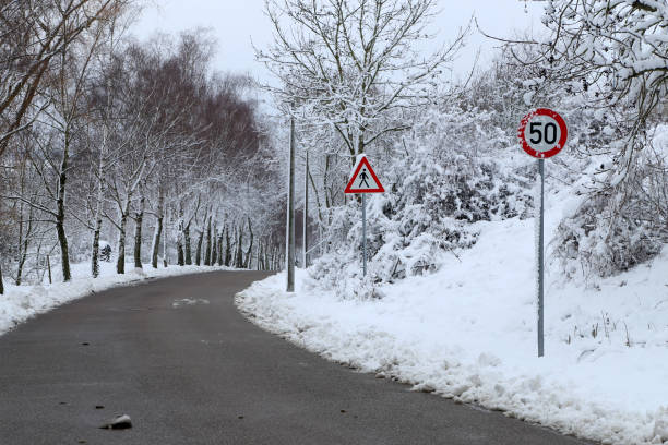 istock Winter landscape with road and road signs 1220002314