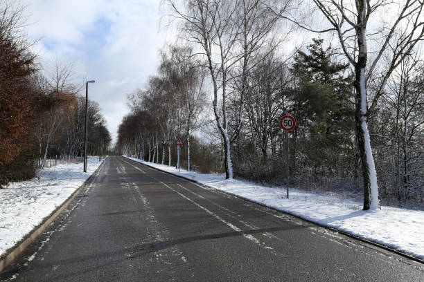 istock First snow. Winter landscape with snow-covered road 1220002675