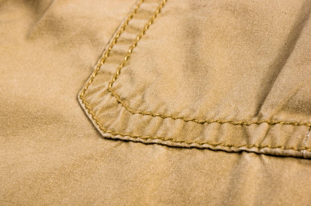 istock clothing items stonewashed cotton fabric texture with seams, clasps, buttons and rivets, macro 1220004957
