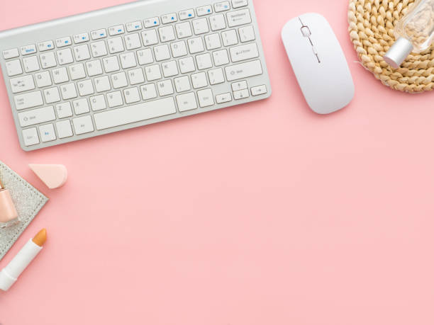 istock Freelancer woman blogger workplace, working space with laptop and perfume cosmetics bottles isolated on light pink table background 1220005066