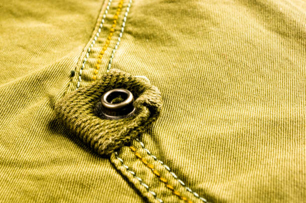 istock clothing items stonewashed cotton fabric texture with seams, clasps, buttons and rivets, macro 1220005089
