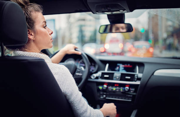 istock Young woman is waiting in a traffic jam in rainy day 1220006178