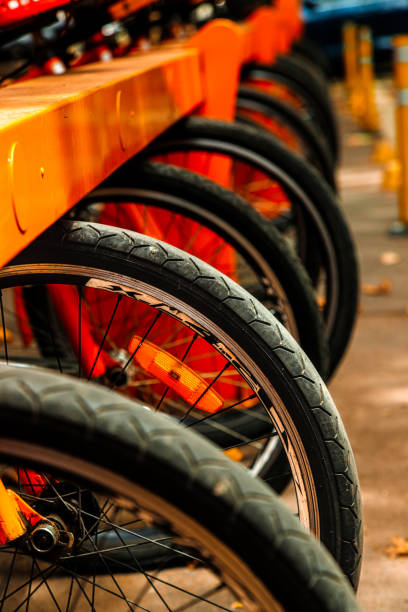 istock Macro closeup of rental bicycle wheels in row 1220007163