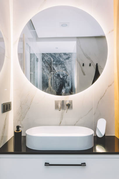 istock Modern sink and round mirror with led light in a luxury bathroom 1220007423