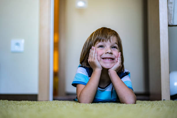 istock Smiling boy is lying on the floor at home 1220008052