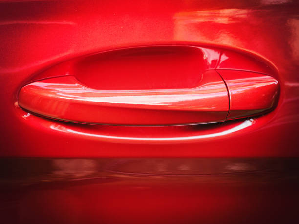 istock Beautiful and elegant handle on a red car door 1220008912
