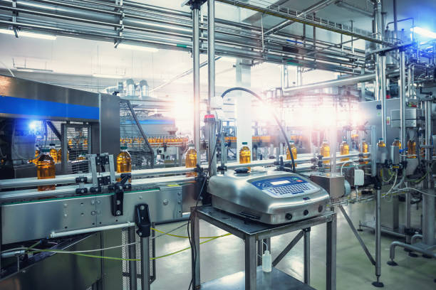 istock Conveyor belt, filled bottles on beverage factory, industry production line 1220009267