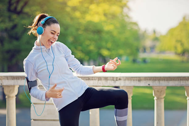 istock Runner girl is playing guitar at her favorite song 1220009823