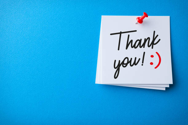 White Sticky Note With Thank You And Red Push Pin On Blue Background