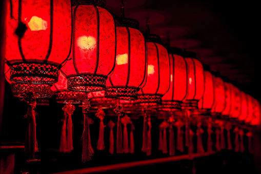 A row of Chinese red lanterns at night.
