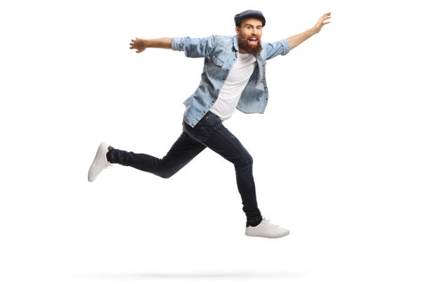 istock Happy bearded hipster guy in casual clothes jumping 1220013062