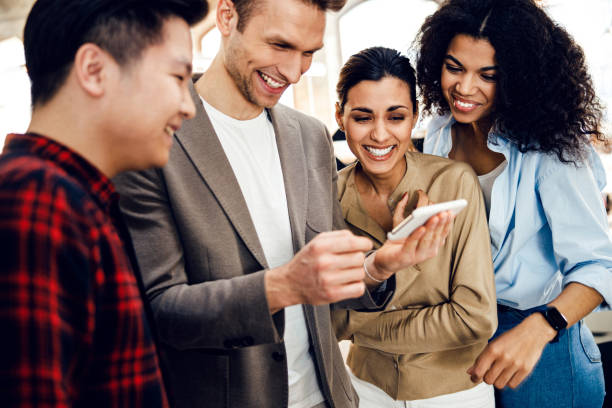 istock Joyful multiracial people watching funny video on cellphone 1220014417