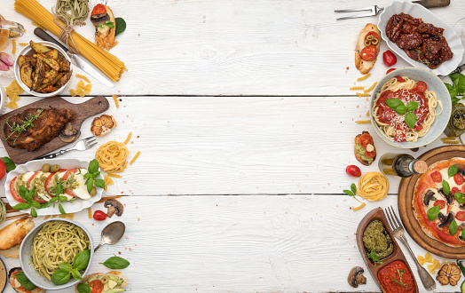 High angle view of  food and ingredients all around it making a colorful frame on rustic wood table. Useful copy space ready for text