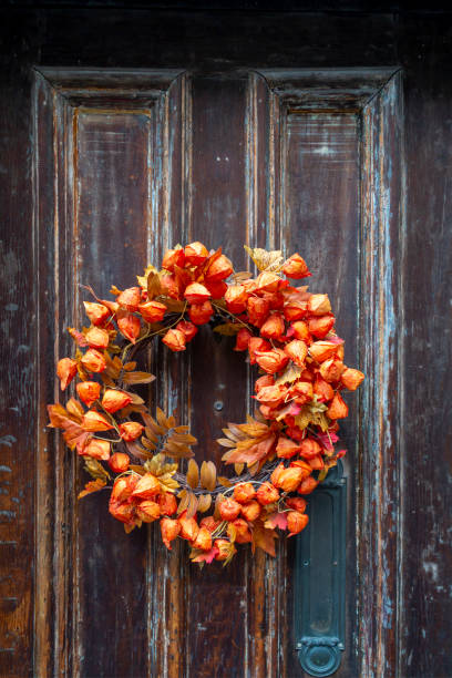 istock outside old front door with a fall festive holiday orange floral reef hanged on it 1220014914