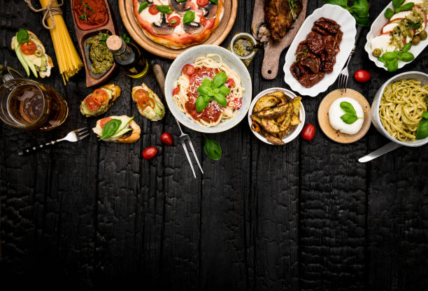 istock Different food cooked on a dark wooden background 1220017903