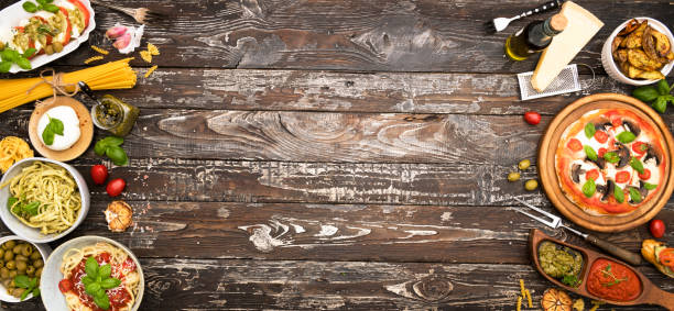 Different food cooked on a wooden table with copy space
