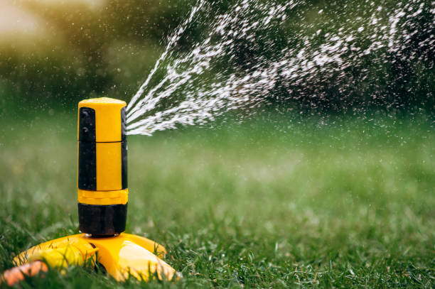 istock watering sprinkle irrigation system grass lawn green summer  raindrops nature wet 1220018052