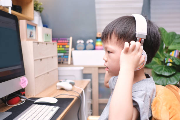 asian toddler boy child using pc computer, little kid at home, kindergarten closed during the covid-19 health crisis, distance learning, activities for kindergarten concept - toddler music asian ethnicity child imagens e fotografias de stock