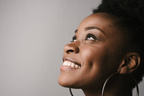 istock Woman looking up and smiling 1220020605