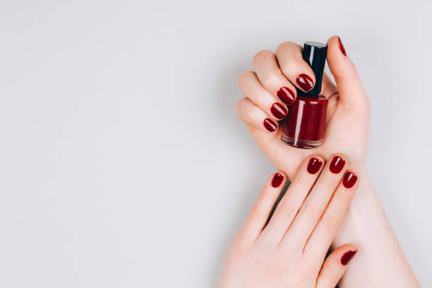 istock Female hands with nail polish 1220021407