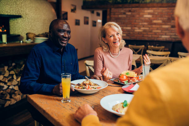 istock Senior friends having a dinner together, laughing and joking 1220021474