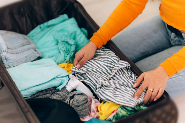istock girl collects suitcase 1220021538
