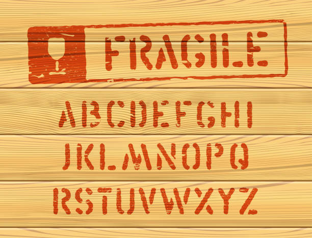 Grunge style vector bold font for parcel shipping Military effect industrial typeset. Fragile freight distressed font. Typeset with rough edged letters. Typography on wooden box texture. Red stamp for container delivery fragile stock illustrations